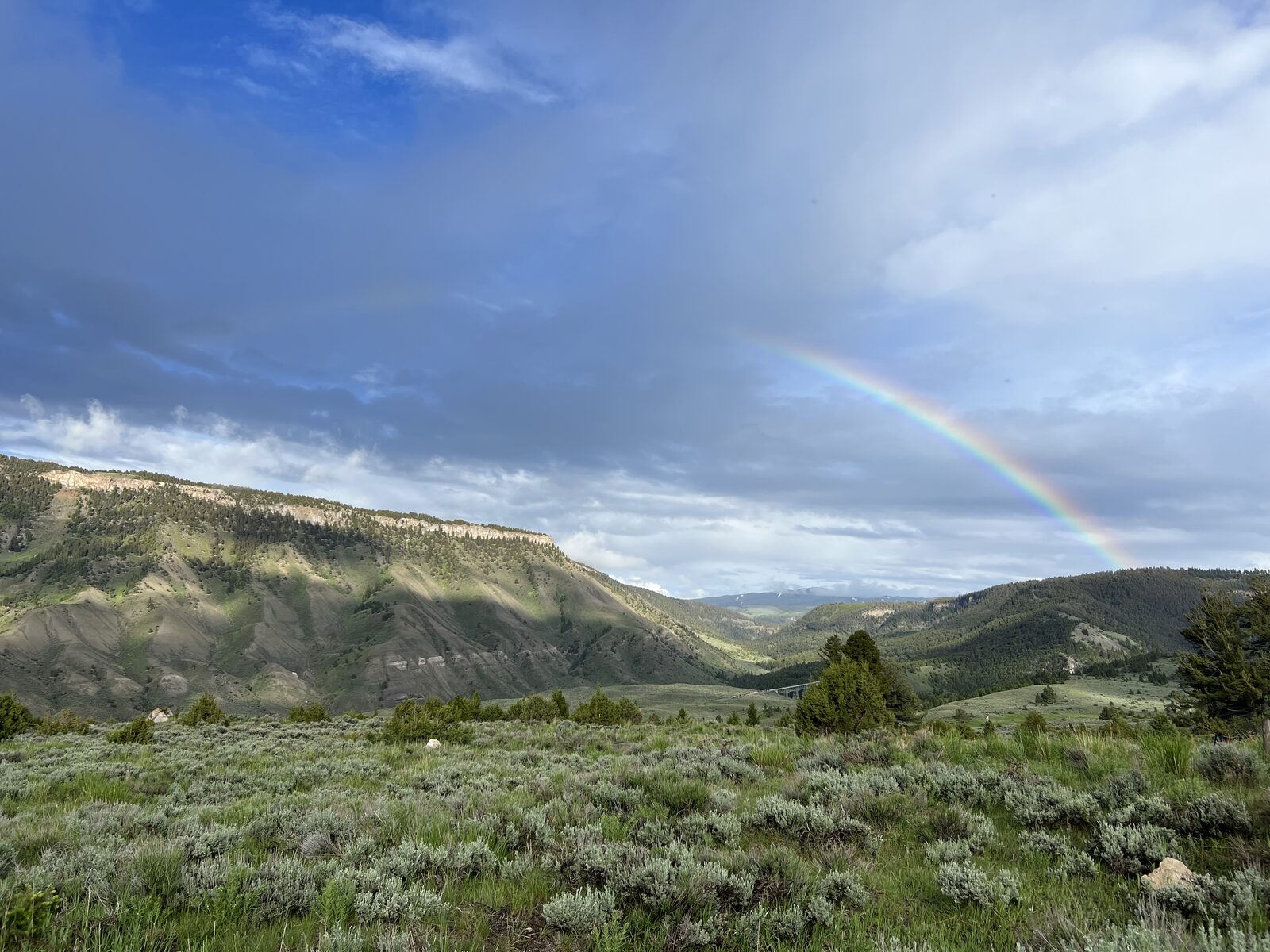 A rainbow over the mountains and valley
